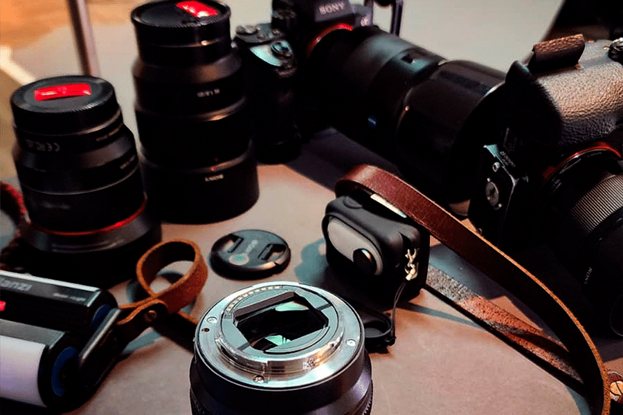 Filmagem para eventos, sobre a mesa, vários equipamentos de filmagem, como câmera de vídeo e lente. 